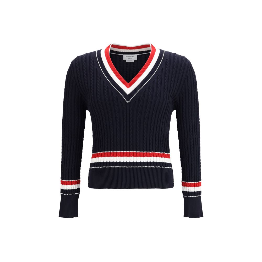 The intarsia cable-knit V-neck Sweater by Thom Browne reimagines the classic cricket pullover with a distinctive contemporary elegance.